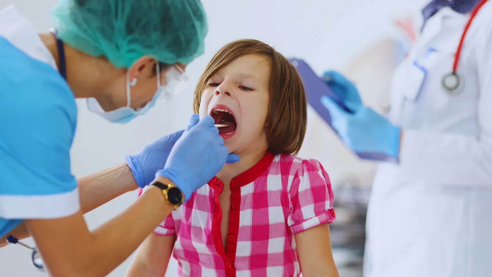Doctor is examining a child for Adenoidectomy